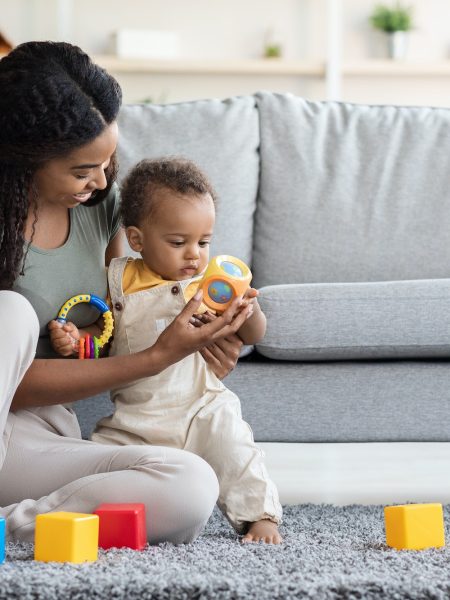 Activities With Babies. Black Mom Playing Toys With Infant Son At Home